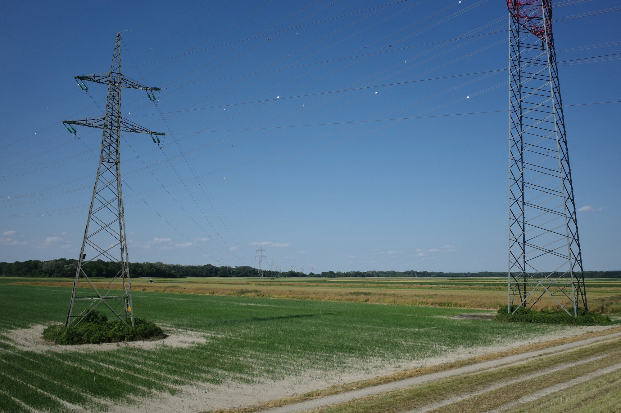 Electricity pylons over open fields